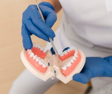 dentist-showing-something-teeth-model_23-2149195934